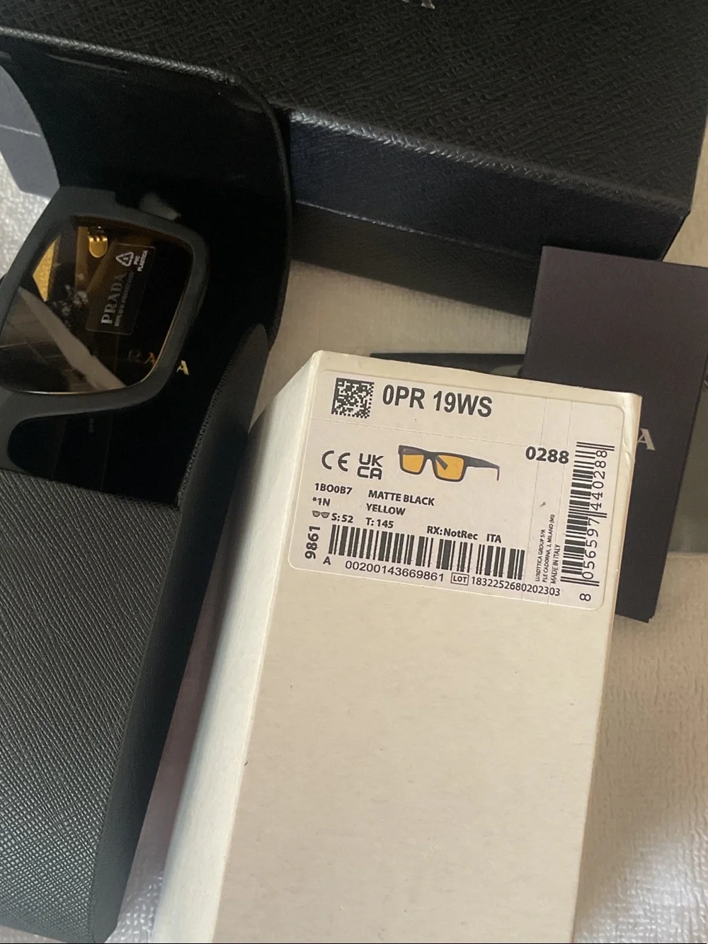 Prada Matte Black Rectangular Sunglasses with Amber Lenses